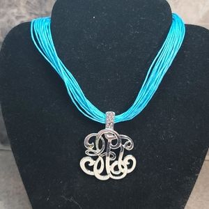 Pendant silver tone.